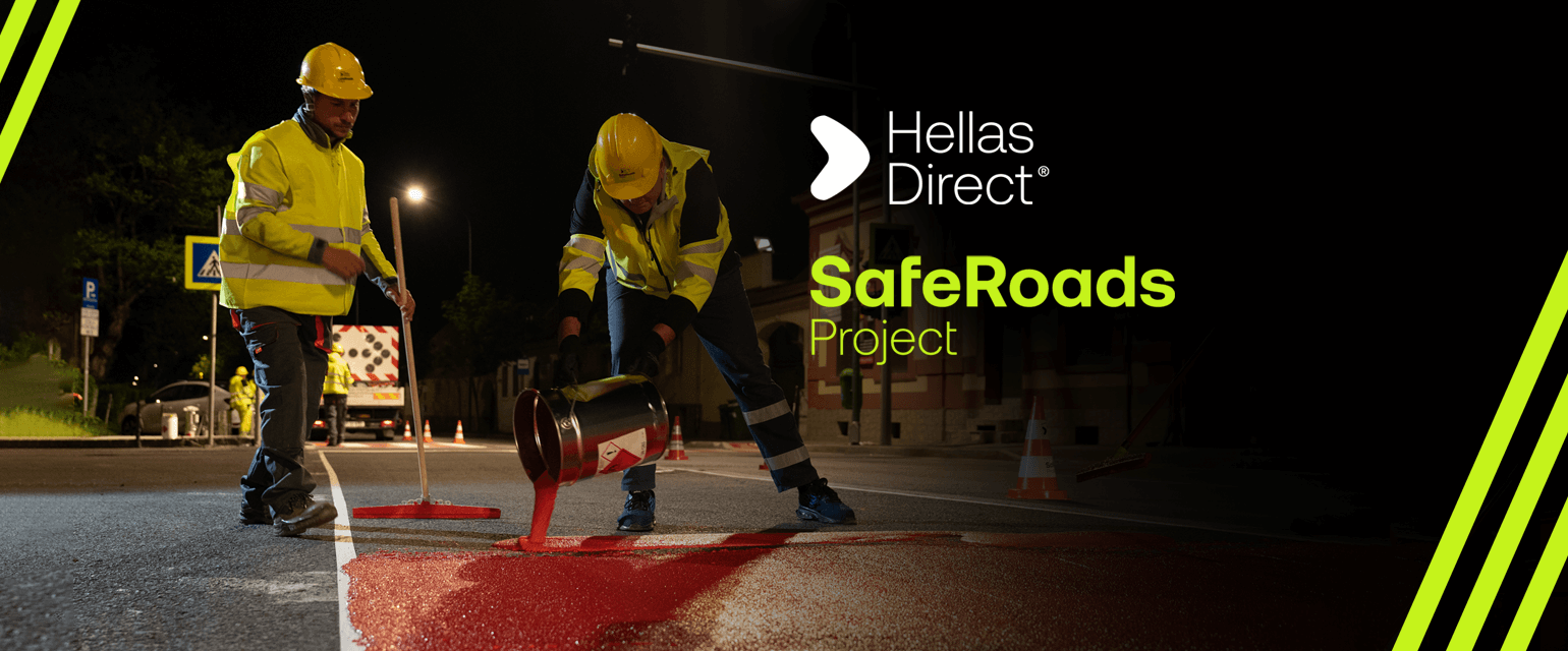 men in yellow vest paint crosswalk outside a school in the night. Written text: Hellas Direct, Safe Roads project