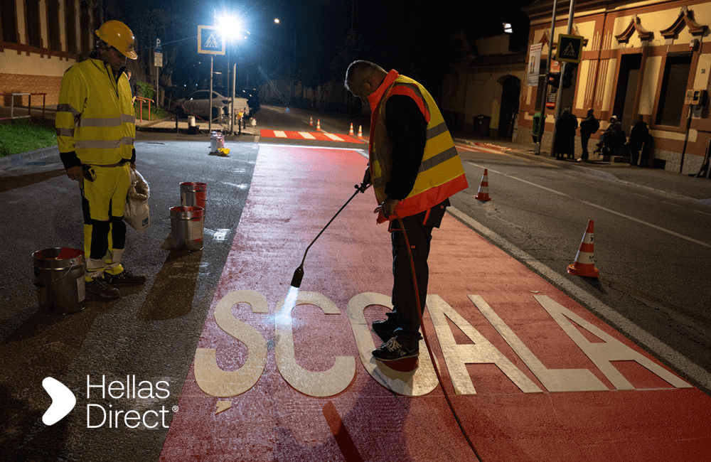 Crew paints crosswalk outside school in the night