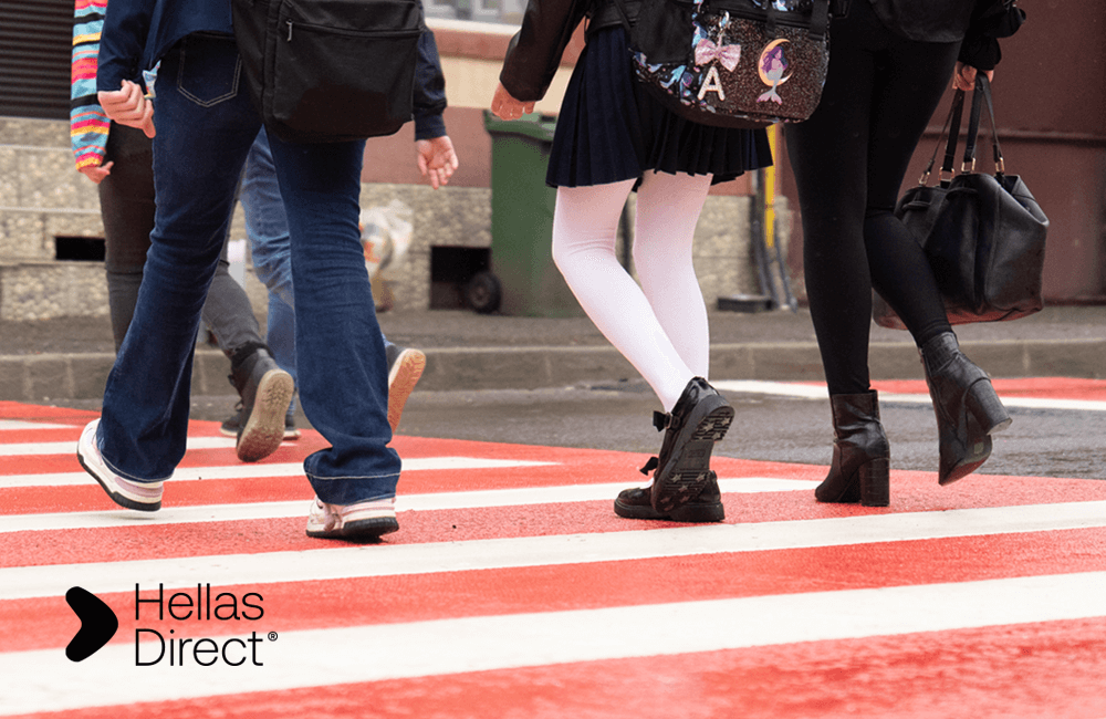 people's feet while walking on a freshly painted crosswalk