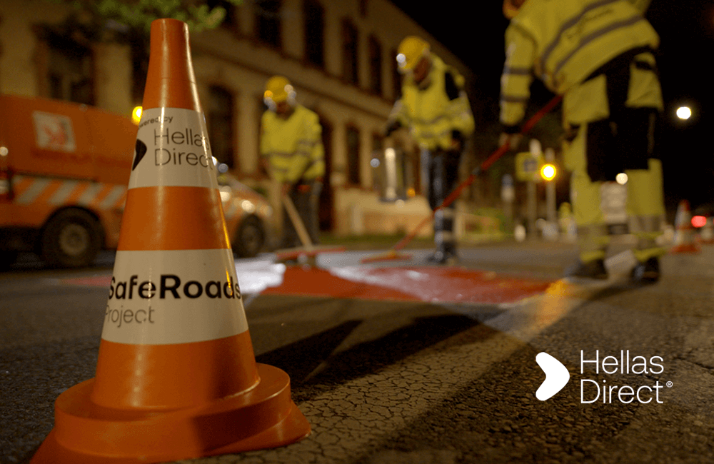 Crew paints crosswalk outside school in the night