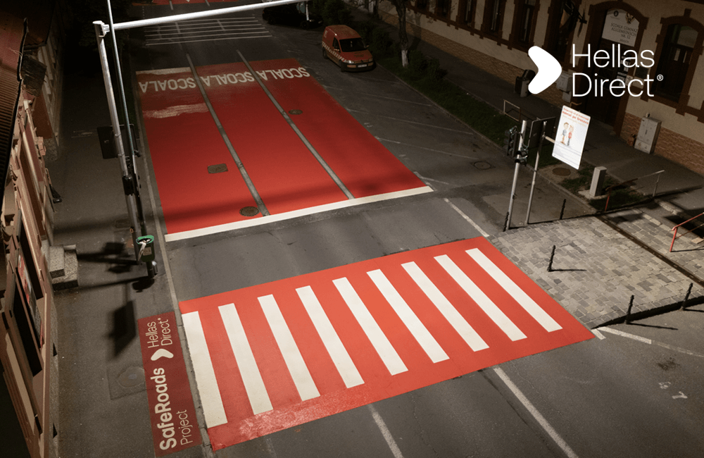freshly painted crosswalk. Written on the pavement: Safe Roads project, Hellas Direct