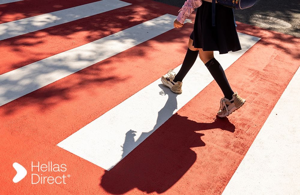 child's feet crossing a crosswalk