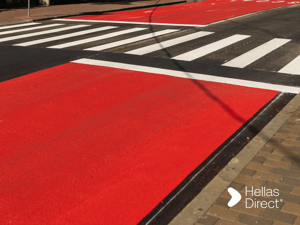 A freshly painted crosswalk outside a school, Hellas Direct logo on the picture